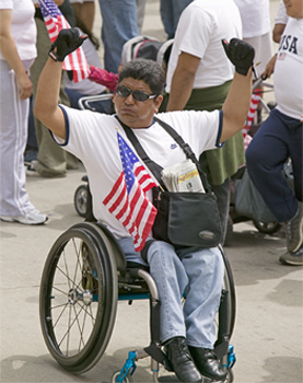 Person in a wheelchair with an American flag.