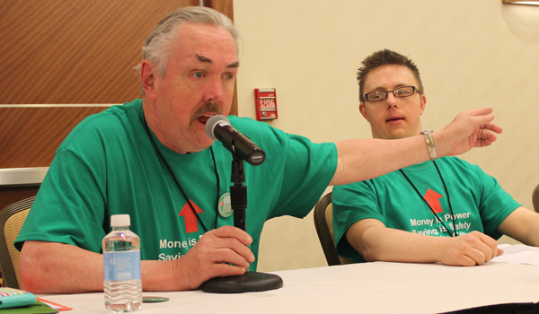 Man speaking at a self-advocacy meeting.